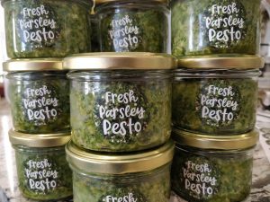 stacks of jars with fresh parsley pesto