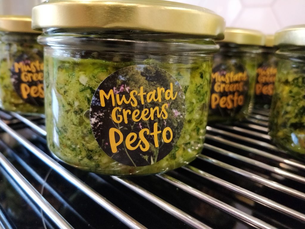 a jar with mustard greens pesto