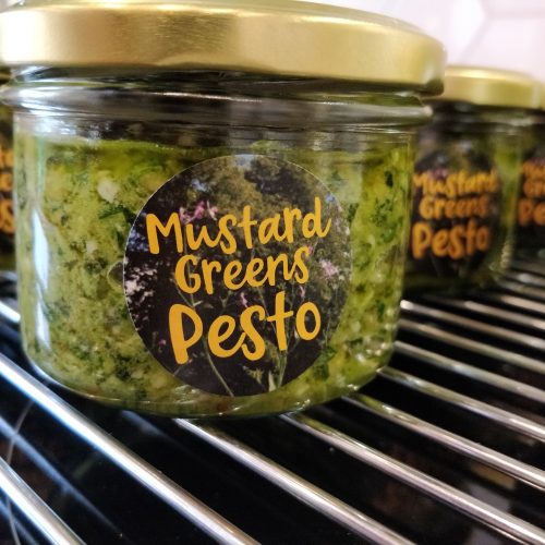 a jar with mustard greens pesto