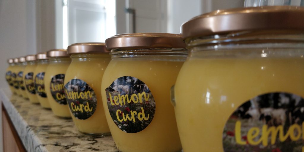 Jars of lemon curd on marble counter top